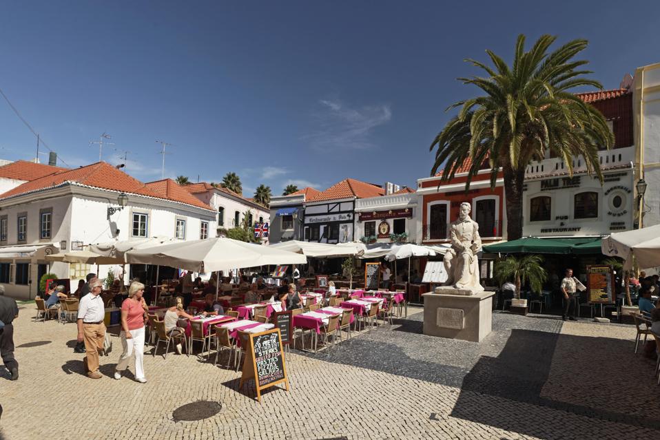 People stroll in the historic downtown of Cascais, near Lisbon, Portugal