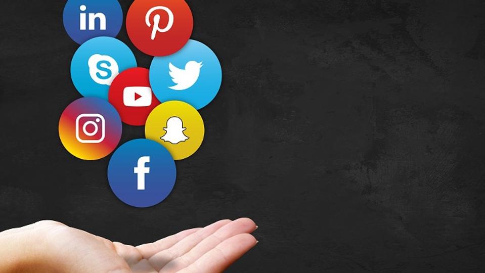 hand holding social media logos