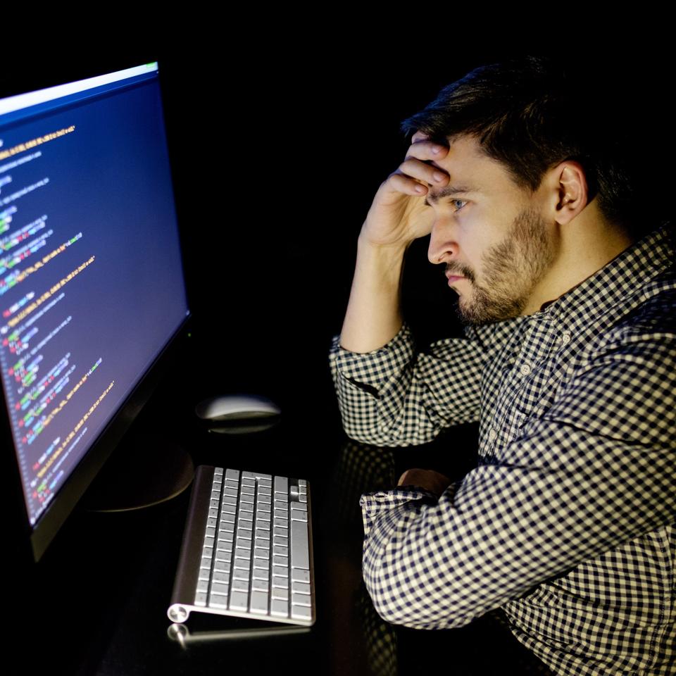 computer-programmer-sitting-in-the-dark