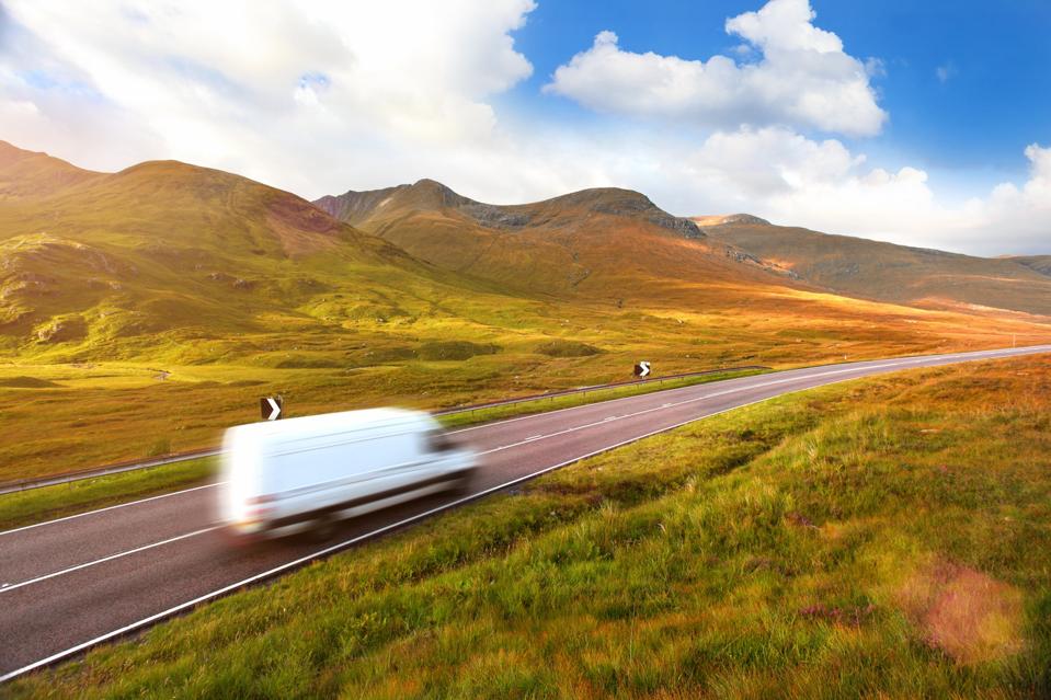 White delivery van speeding on a country road