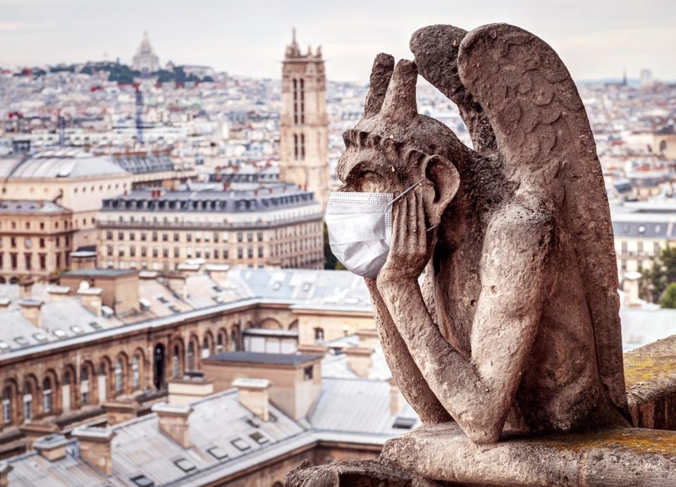 A gargoyle on Notre Dame in Paris–France is opening its border to arrivals from 7 non-EU countries