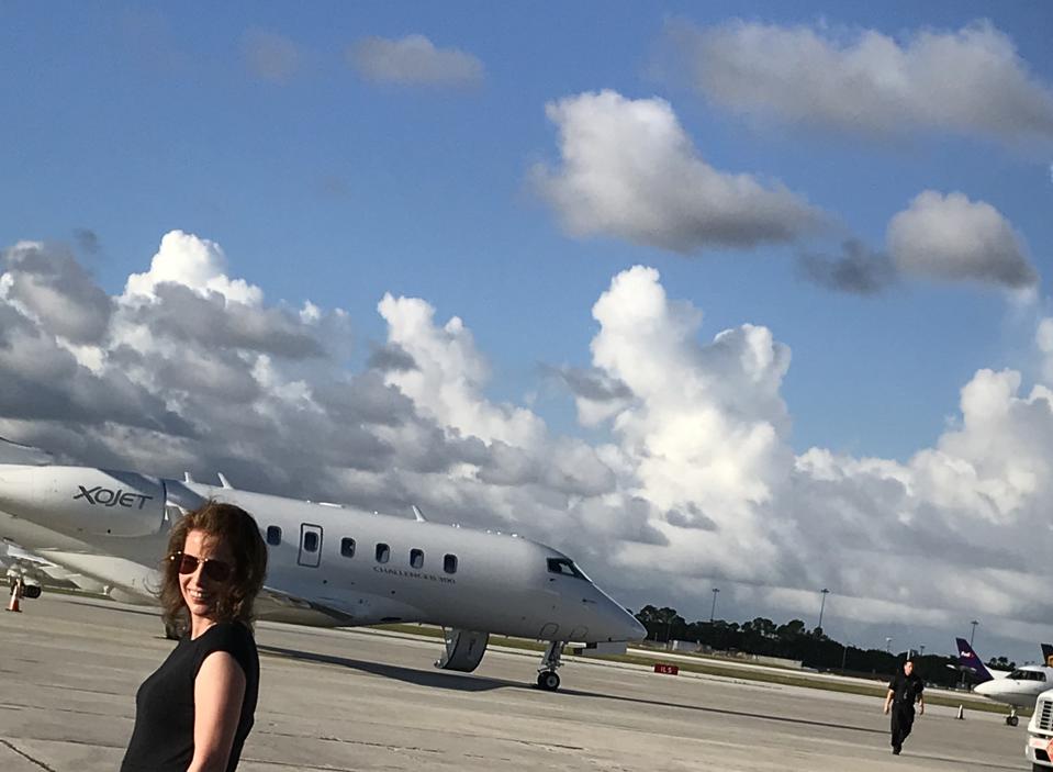 JetsetPrivate Air founder and CEO Jacqueline Zimmerman on an airstrip with a private jet