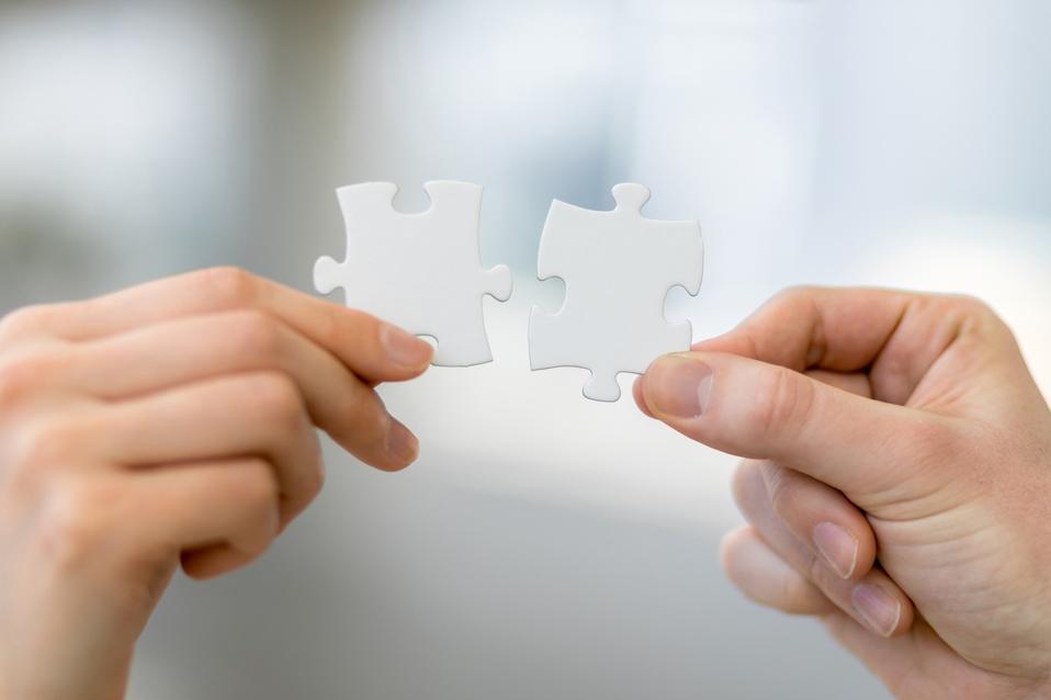 man and woman hand holding jigsaw puzzles, business matching concept