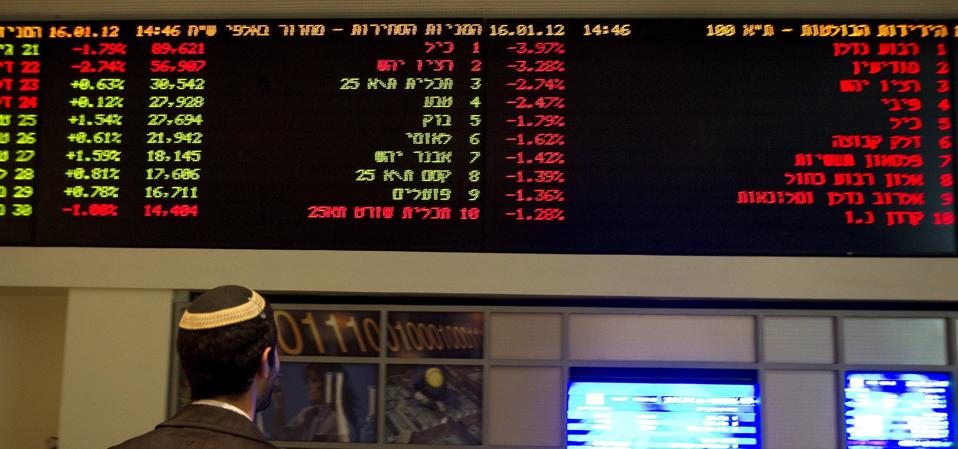 A traderlooks at a screen at the Tel Avi