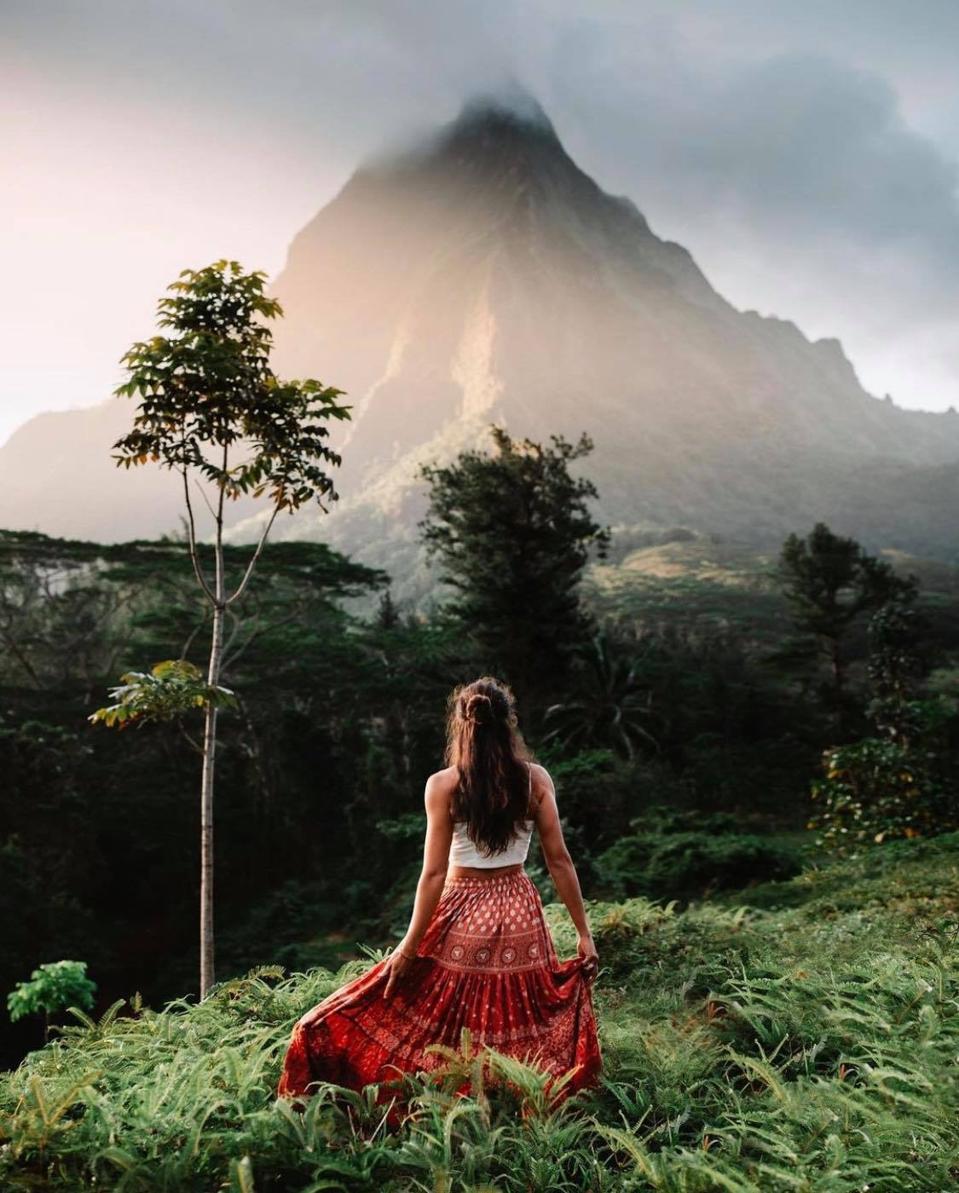 Travel influencer Chelsea Kauai in front of a remote mountain.