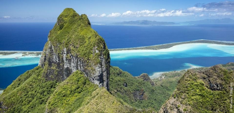 One of the many islands of Tahiti with vegetation growth.