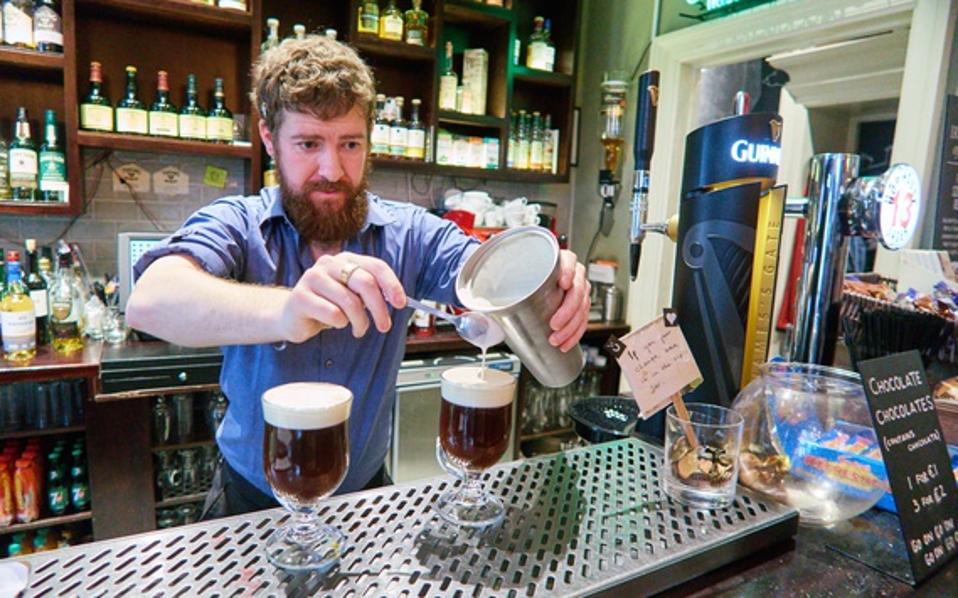 Prior to the pandemic, a bartender prepares Irish coffee at the Irish Whiskey Museum in Dublin, Ireland. (Photo by EyesWideOpen/Getty Images)