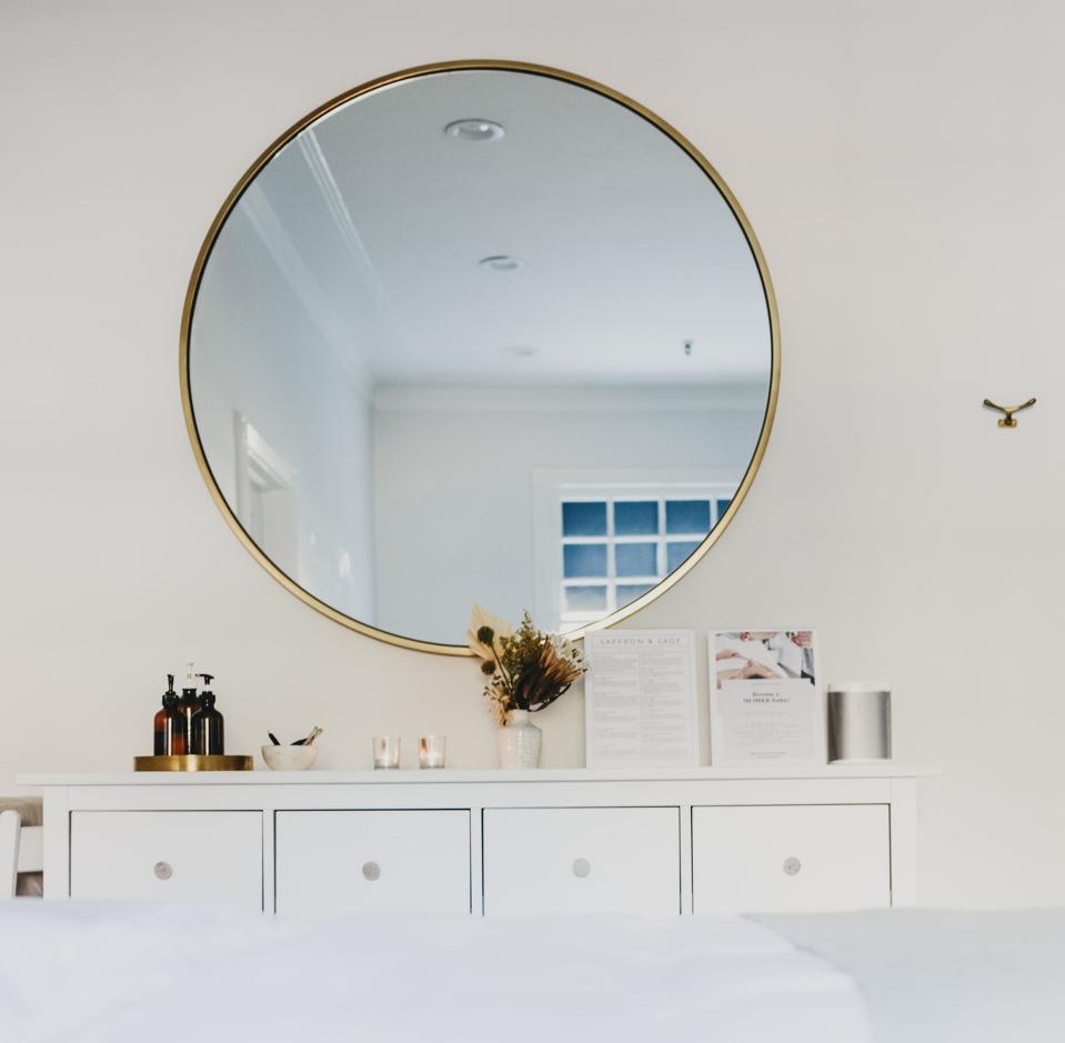 A spa room with a mirror at Saffron and Sage.