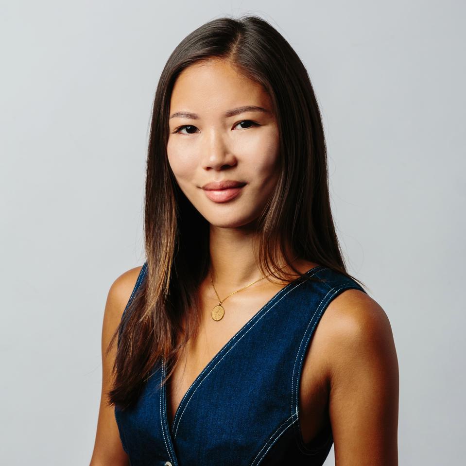 Image of woman with brown hair in a jean dress