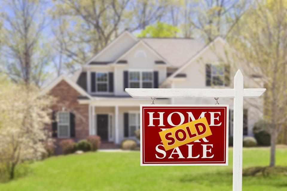 House for sale sign, marked sold