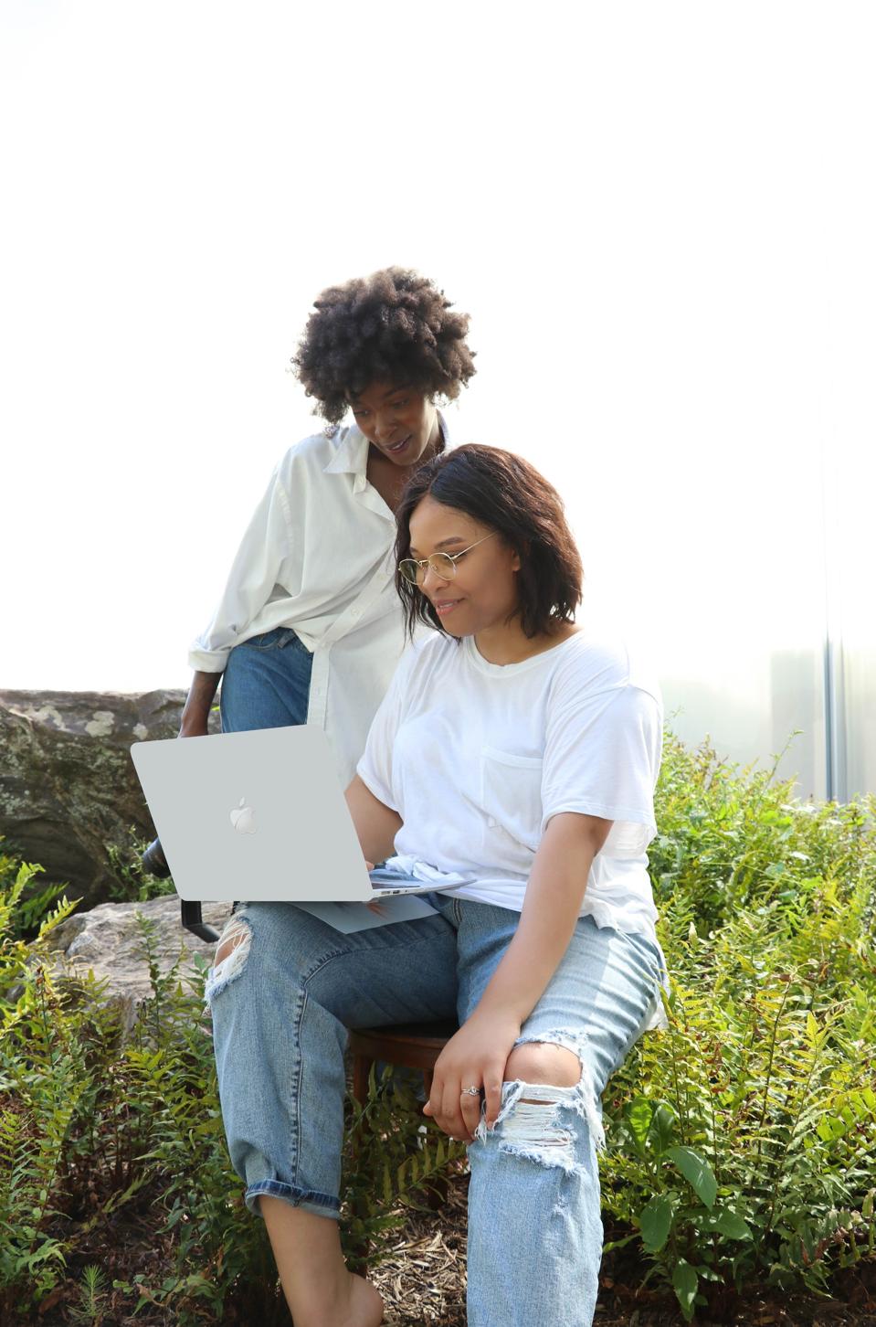 Two women looking at a laptop Earth and Olive