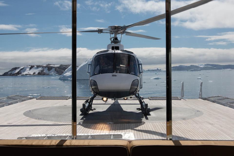 A helicopter on the back of a superyacht in the Arctic