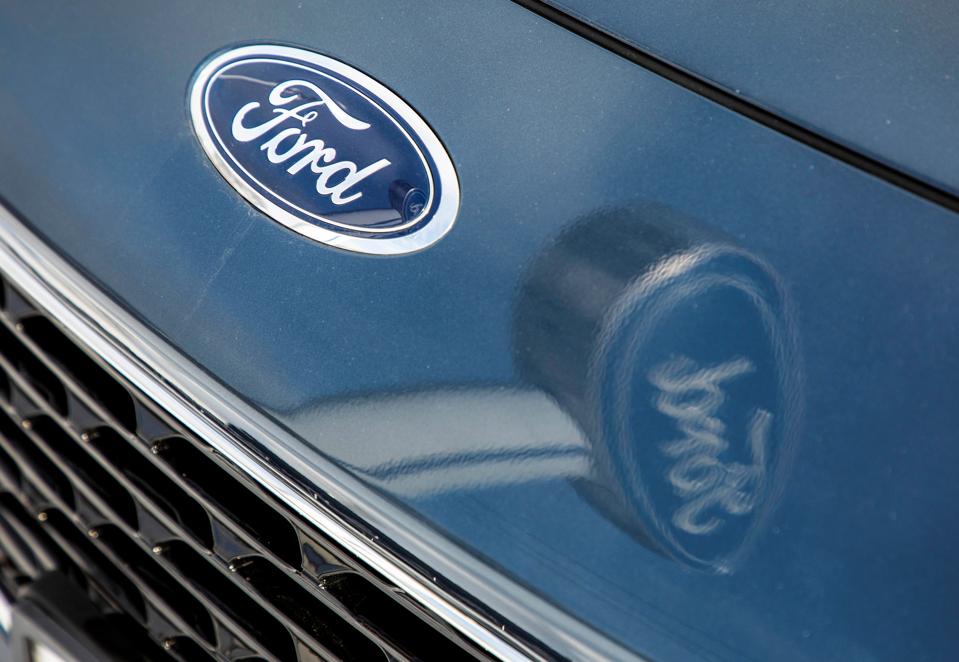 Ford logo on car and reflected in car hood.