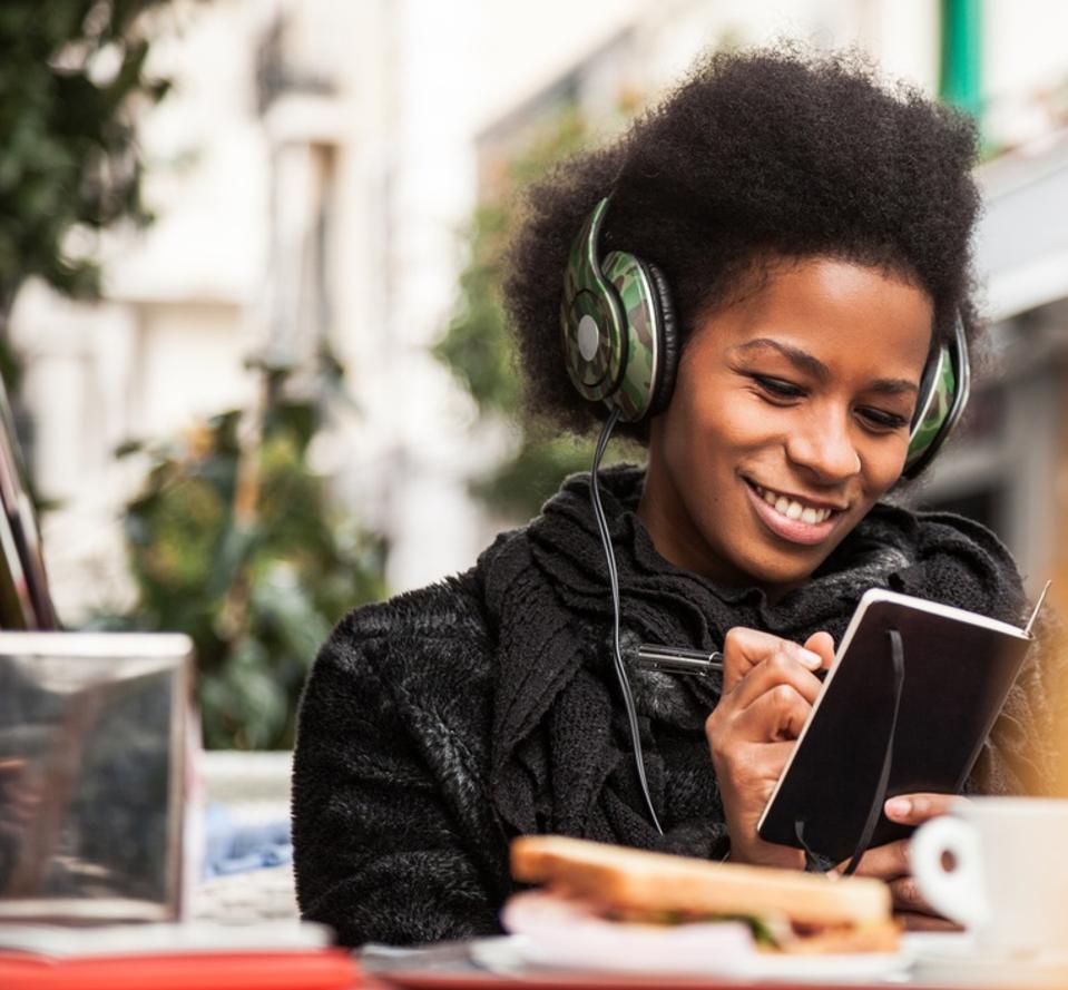 Woman consulting agenda and listening to music