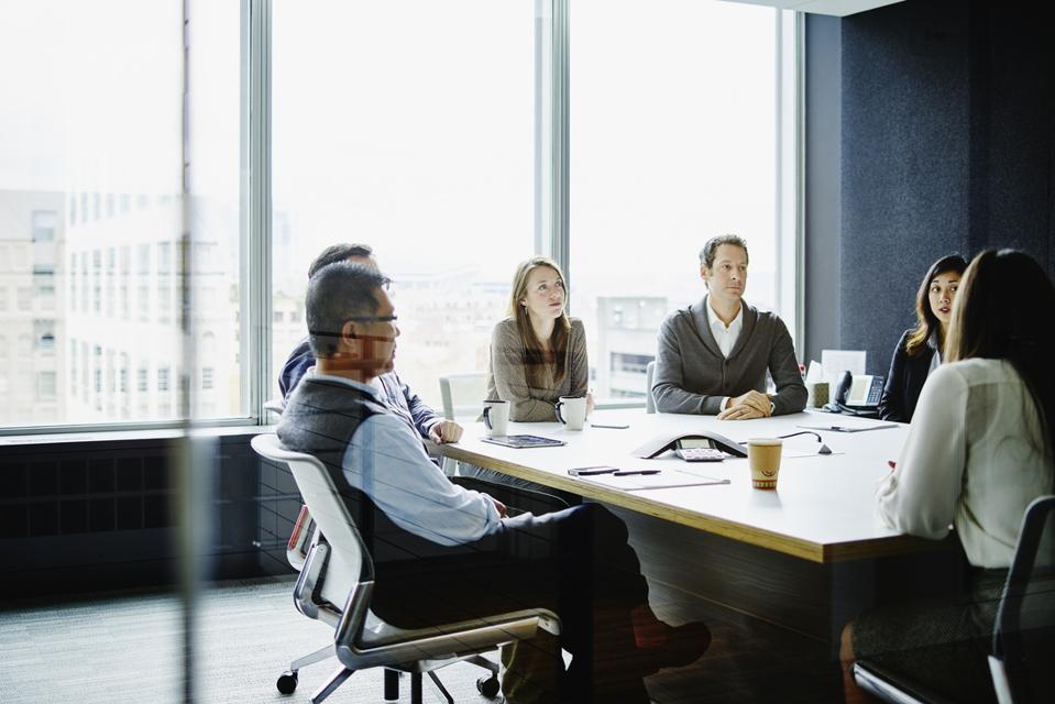 Coworkers in morning meeting in conference room