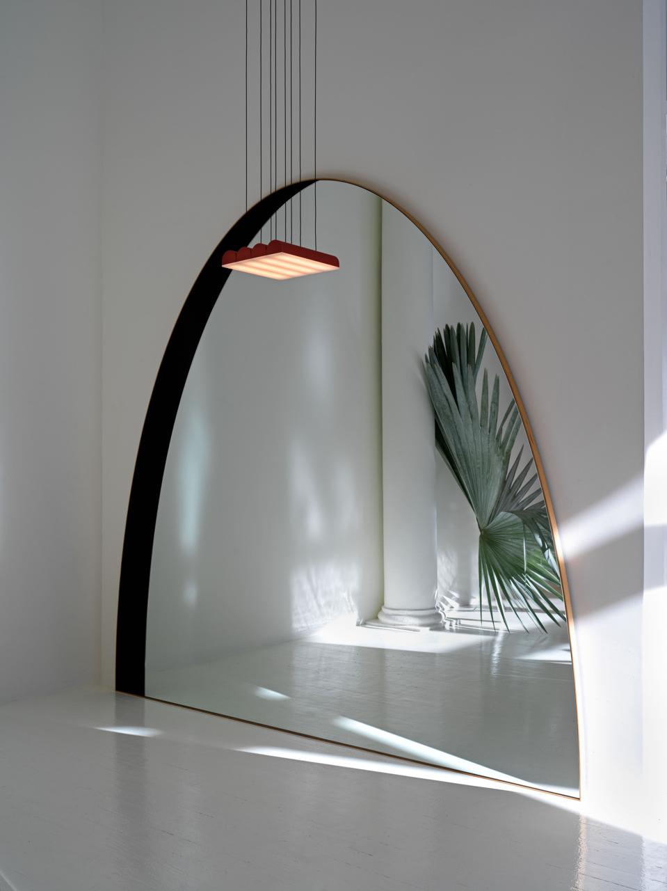 A mirror from local designers Bower Studios reflects one of the light installations from L&F's Atelier collection.