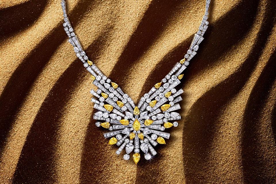 The Sun Worship necklace features 374 white and yellow diamonds with a 10.56-carat pear-shaped Fancy Vivid Yellow diamond in the center.  