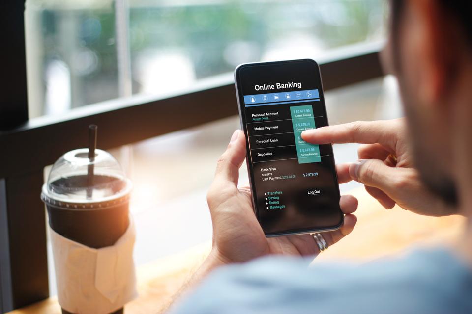 Man using online banking technology on touch screen device.
