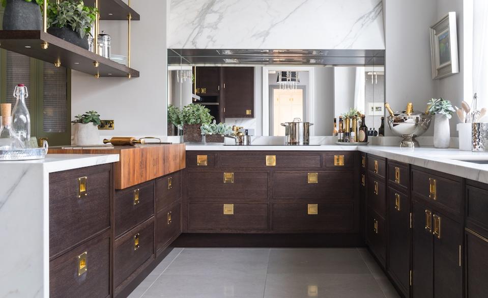 A kitchen with wood and marble finishes