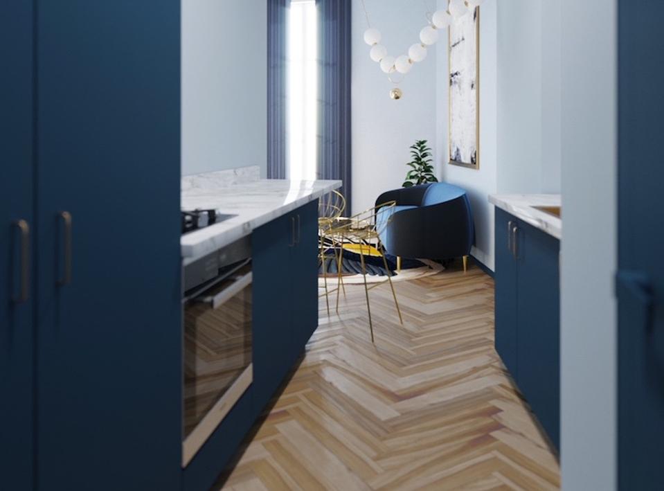 A blue kitchen and living room with wood floors throughout.