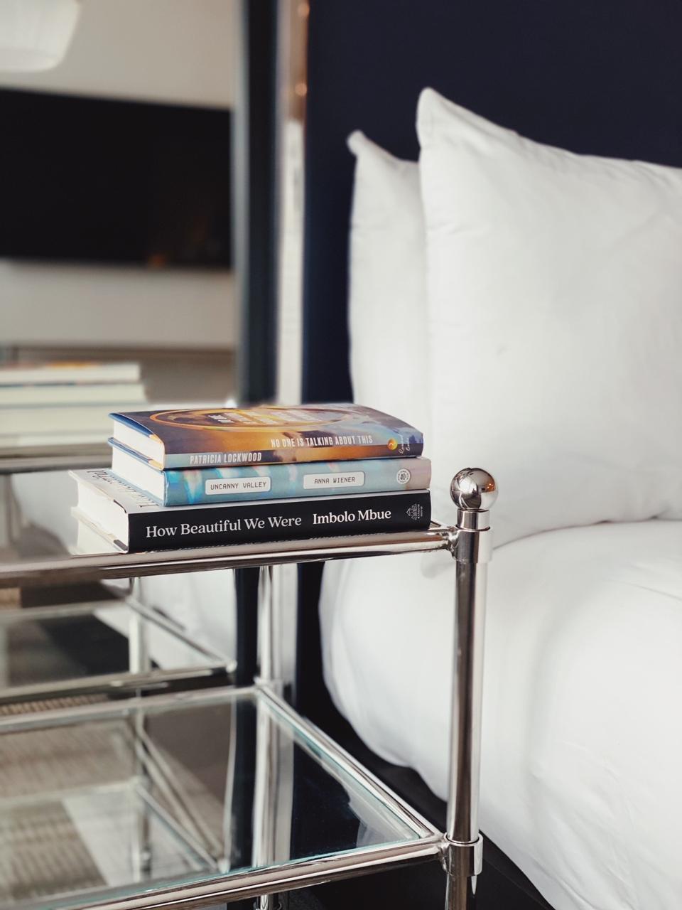 A nightstand at the Palomar Philadelphia with three current books.