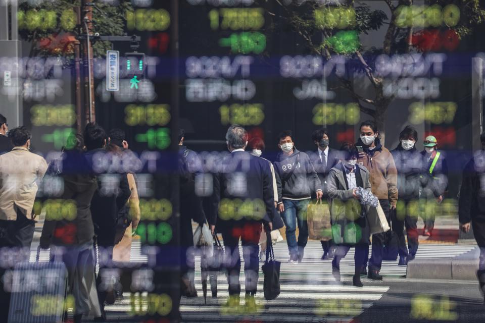 A cross road is being reflected by an electronic board...