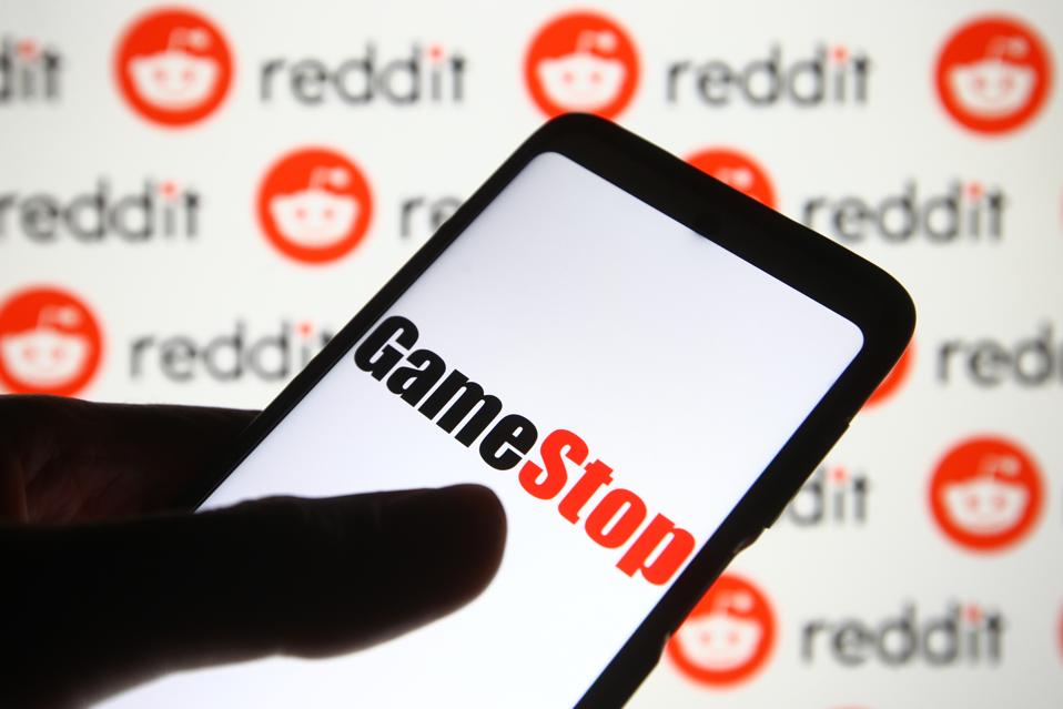 In this photo illustration a GameStop logo is seen on a...