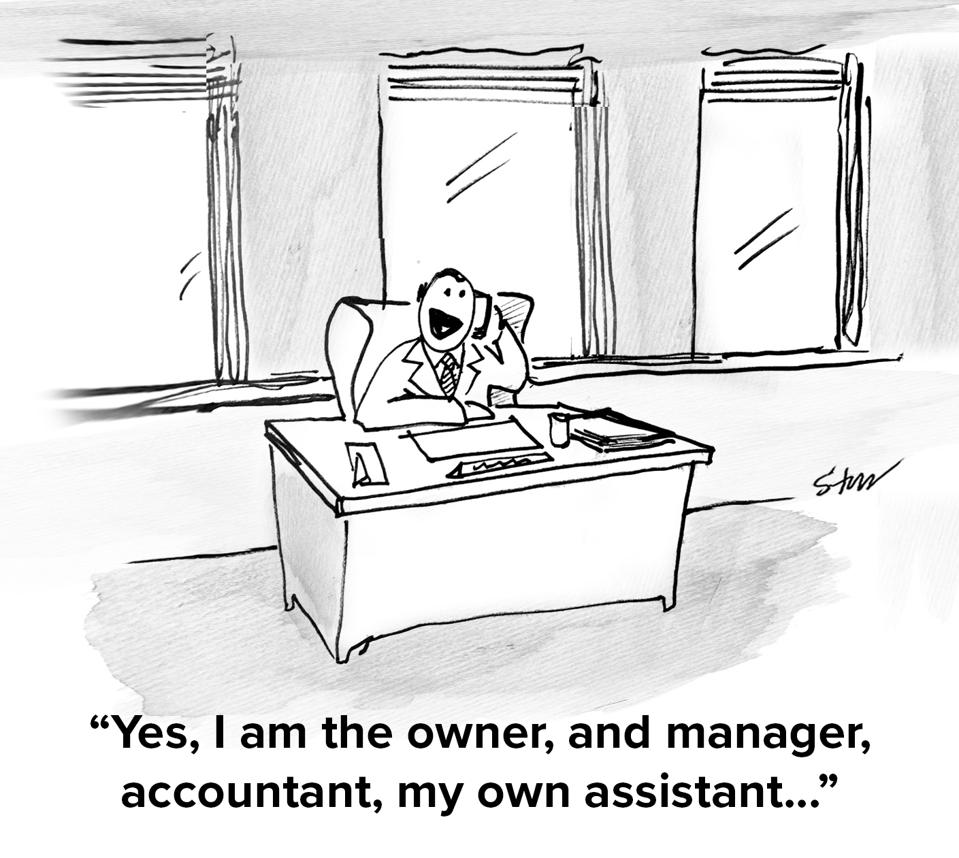 A business man sitting at a desk in an empty office alone on the phone saying ″Yes, I am the owner, and manager, accountant, my own assistant...″
