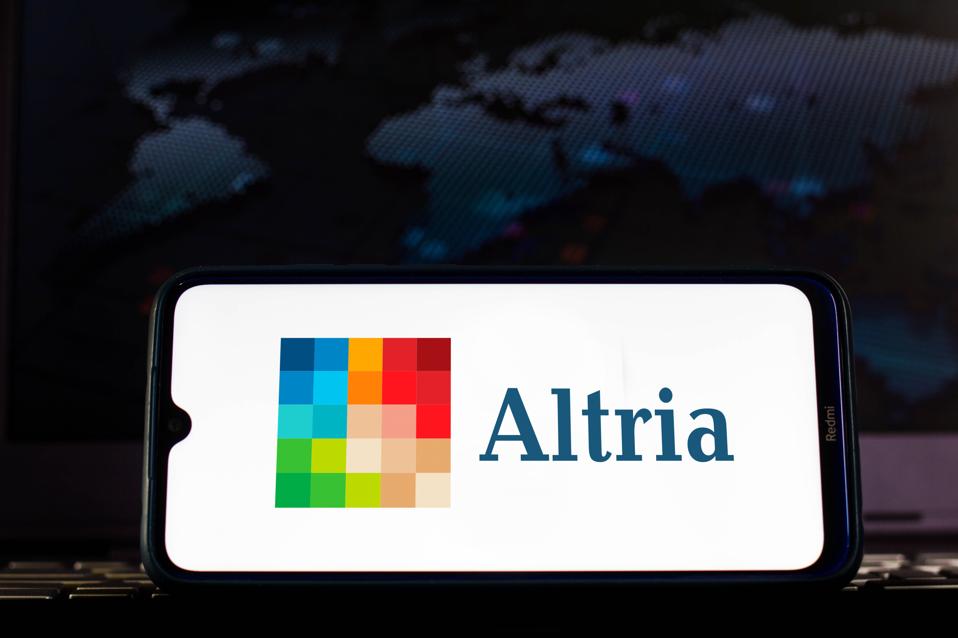In this photo illustration the Altria logo seen displayed on...