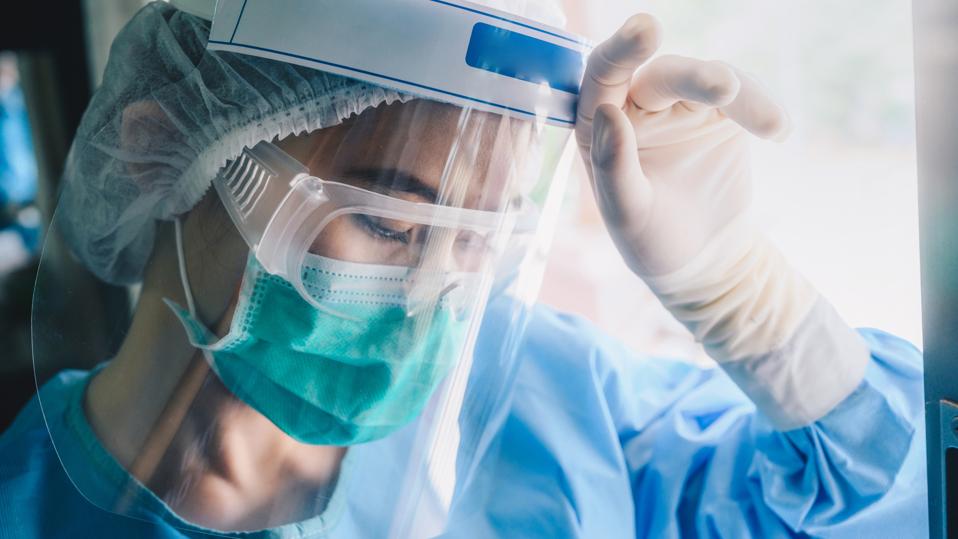 Nurse having headache and tired from work while wearing PPE suit for protect coronavirus disease.
