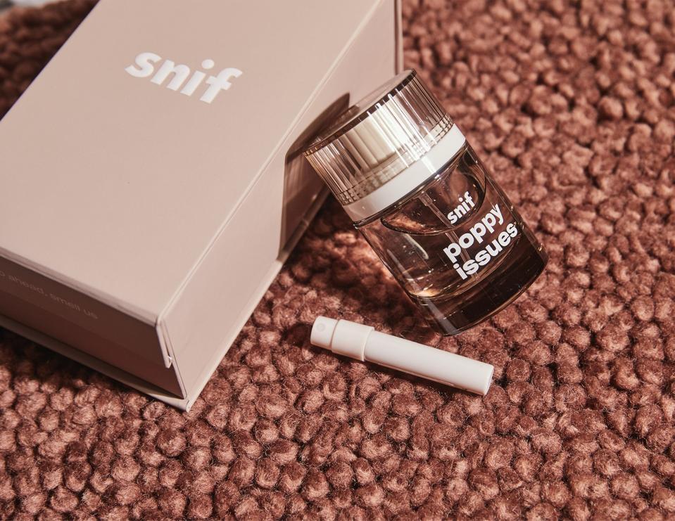 a bottle of perfume next to a box