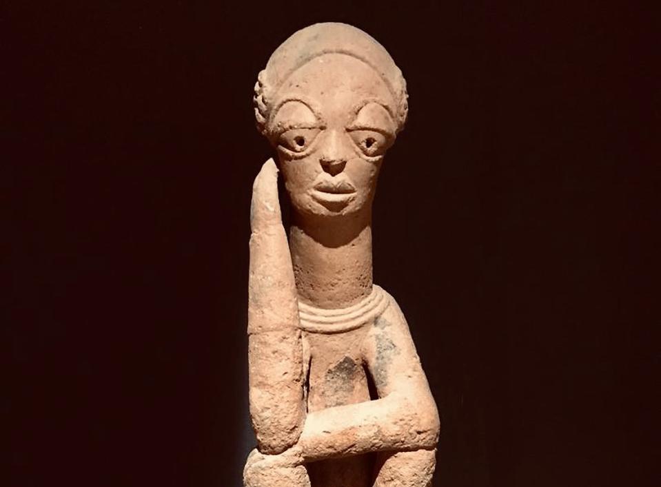 An ancient sculpture from Dakar's Museum of Black Civilizations depicting a pensive woman
