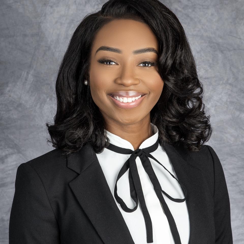 Headshot of Michelle Adibe smiling.