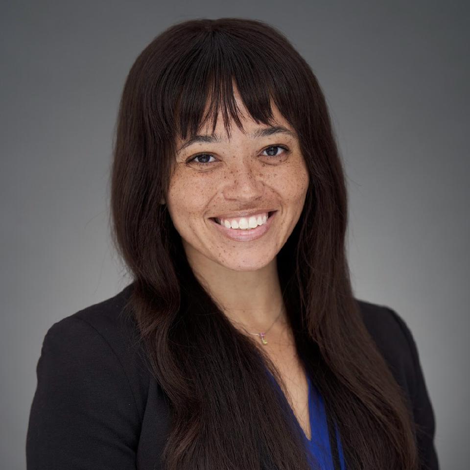 Headshot of Erin Adams smiling.