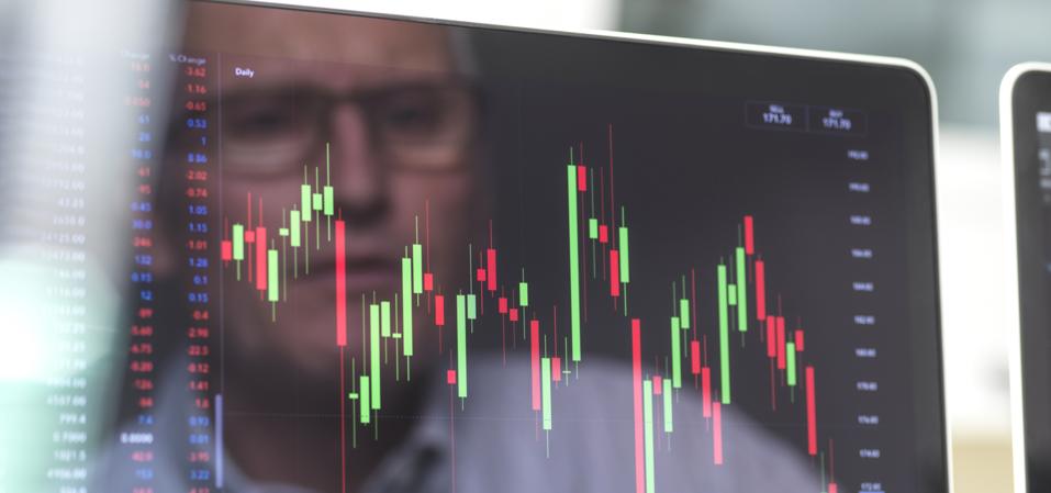 Reflection of a stock trader viewing the performance of a company share price.