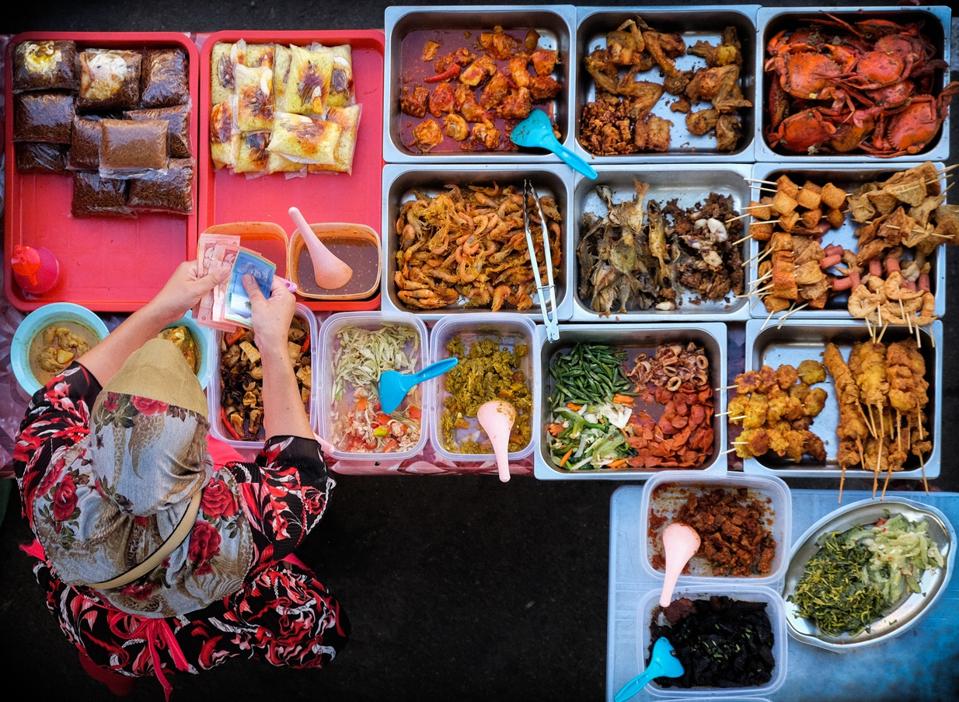 Directly Above Shot Of Woman Standing At Street Food Stall Singapore.