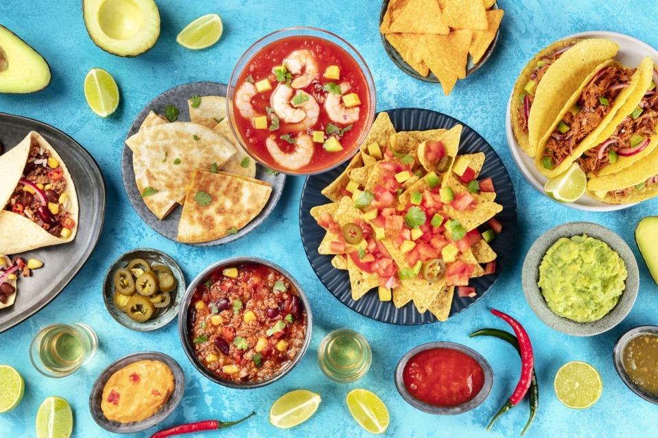 Mexican food, overhead shot:. Nachos, tequila, guacamole, chili con carne, burritos, tacos