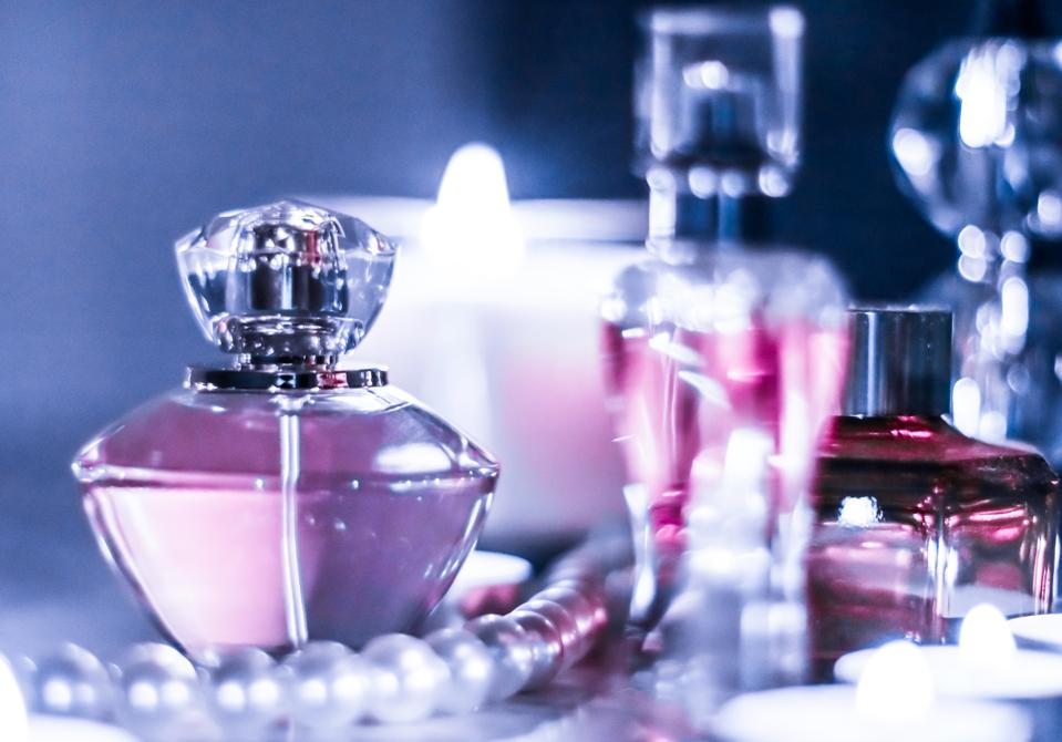 Perfume bottle and vintage fragrance on glamour vanity table at night, pearls jewellery and eau de parfum as holiday gift, luxury beauty brand present