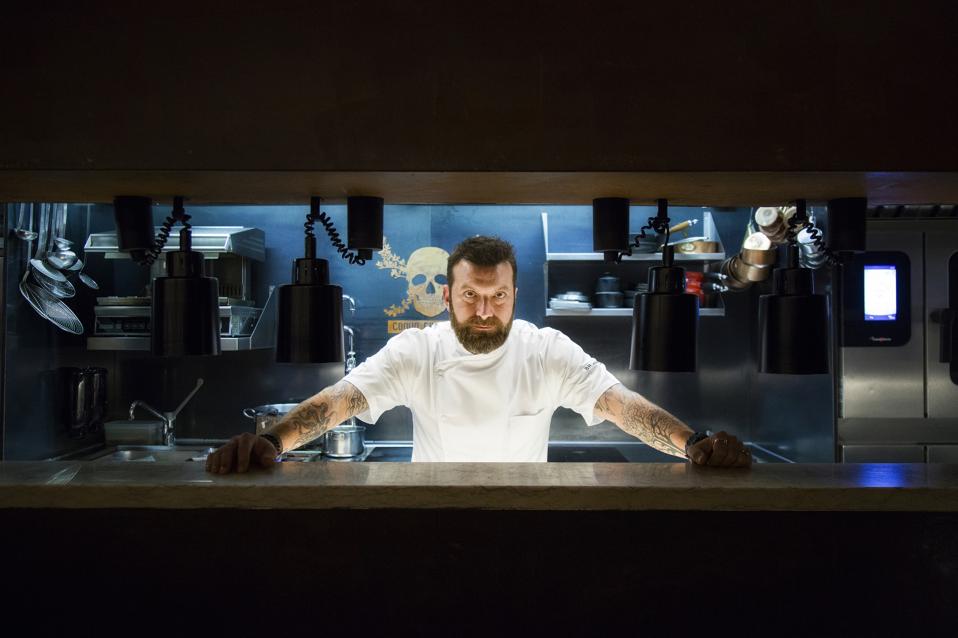 Chef Ljubomir Stanisic stands proudly behind the counter at 100 Maneiras in Lisbon