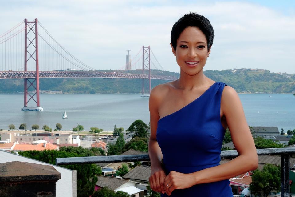 Tour operator Sheree Mitchell stands in front of the bridge in Lisbon, Portugal