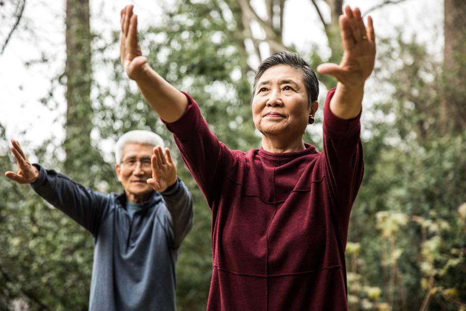 Senior couple doing Tai Chi outdoors