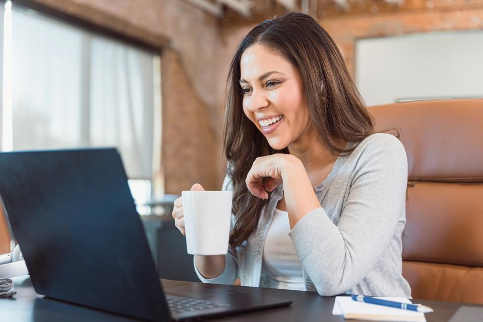 Happy woman video chats with friend