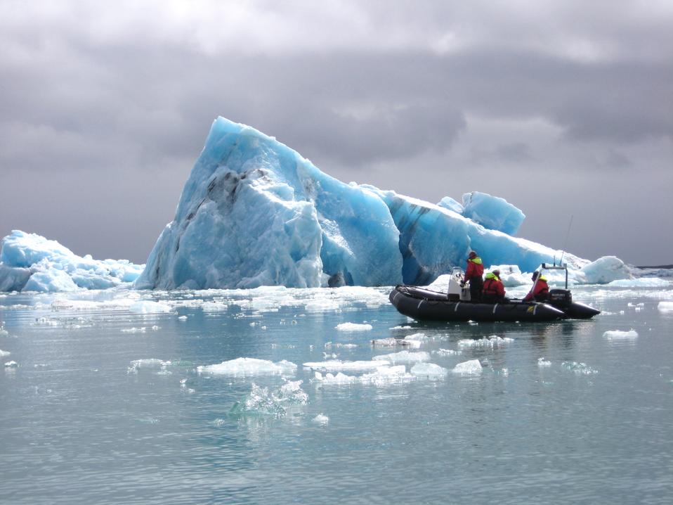Skimming past icebergs in a Zodiac boat in Iceland.