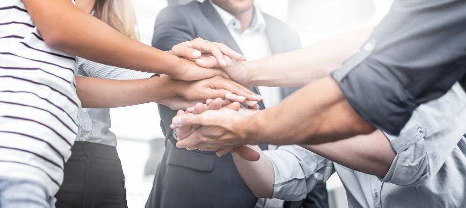 5 Tips For Helping Your Team Find Motivation In Post-Covid 2021 3 Stack of hands. Unity and teamwork concept.