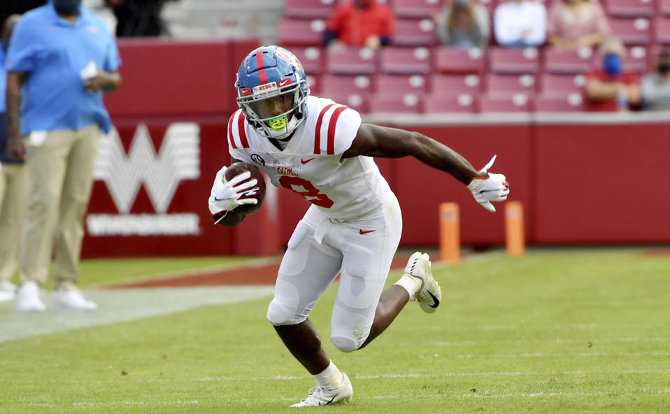 Elijah Moore, a potential first-round pick in the 2021 NFL Draft, runs with the ball.