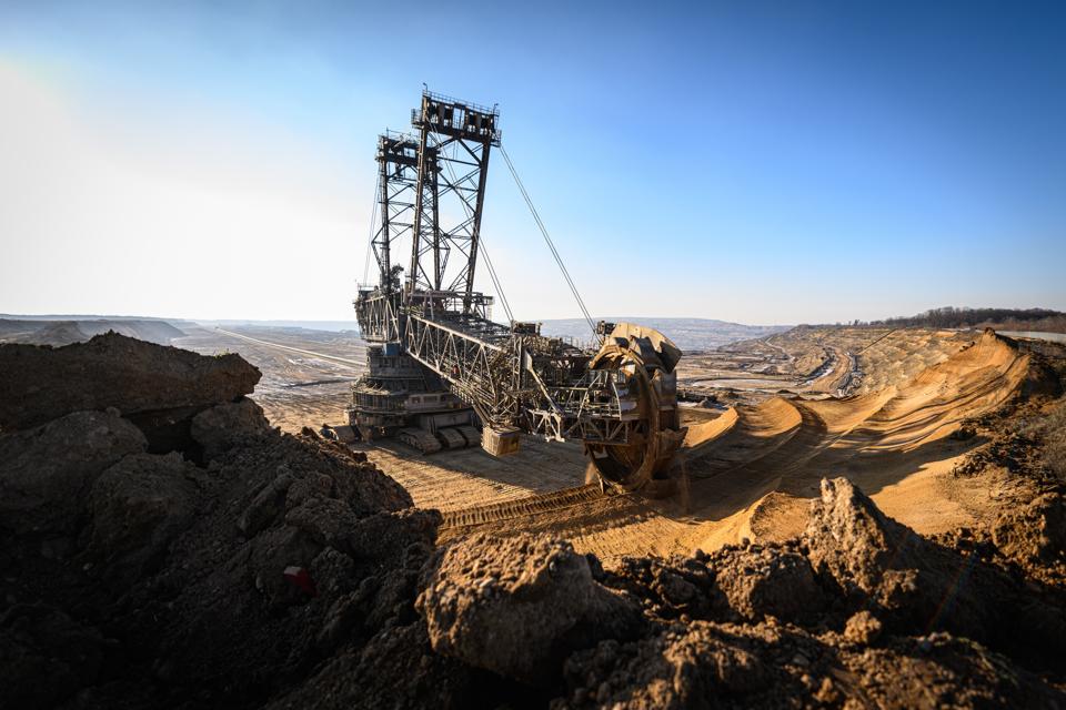 Covid Vs Coal: Has The Pandemic Accelerated Europe’s Green Energy Transition? 3 A vast excavating machine mines lignite coal under a blue sky in Germany.