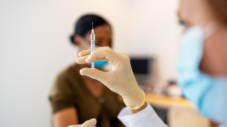 Several States Halt Johnson & Johnson Vaccine After U.S. Regulators Recommend Pause 2 Doctor preparing flu or coronavirus injection