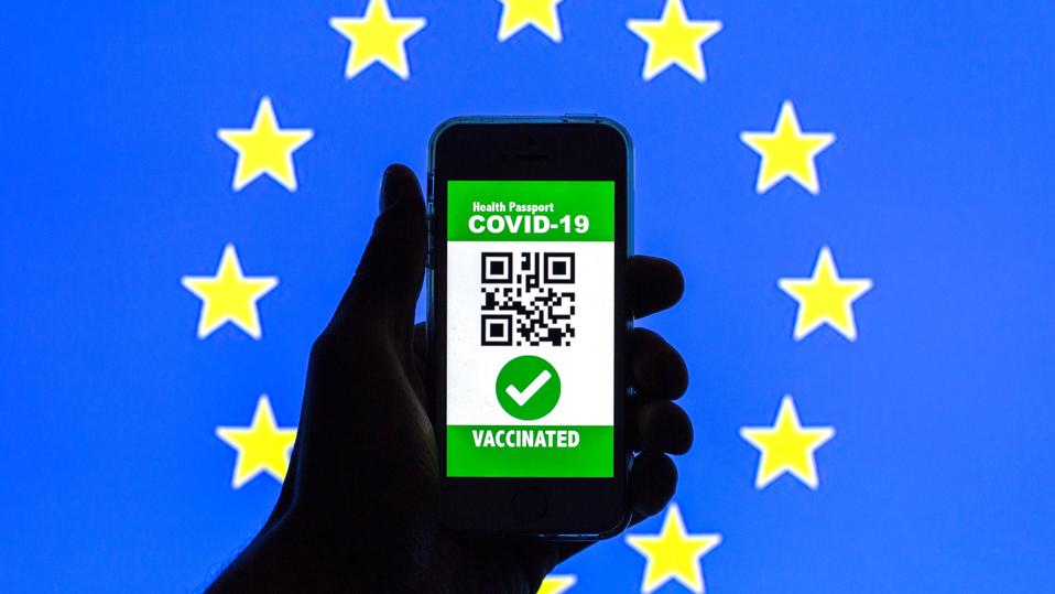 Europe Warms To Summer Vacations—But You Will Need To Pack A Covid Certificate 3 In this photo illustration, a symbolic COVID-19 health...