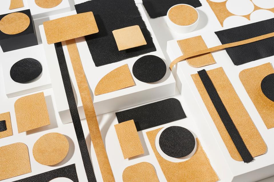 A display of mushroom-based leathers in black and yellow tan.