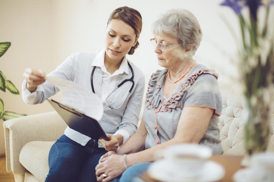 Young female doctor is consulting a senior patient